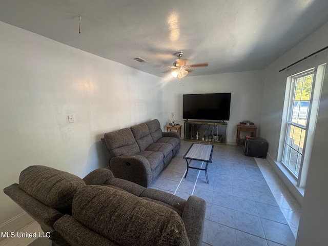 tiled living room featuring ceiling fan