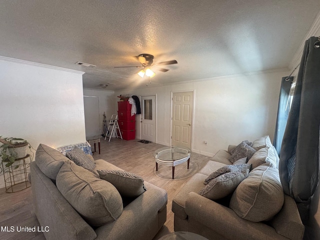 living room with a textured ceiling, ceiling fan, crown molding, and light hardwood / wood-style floors