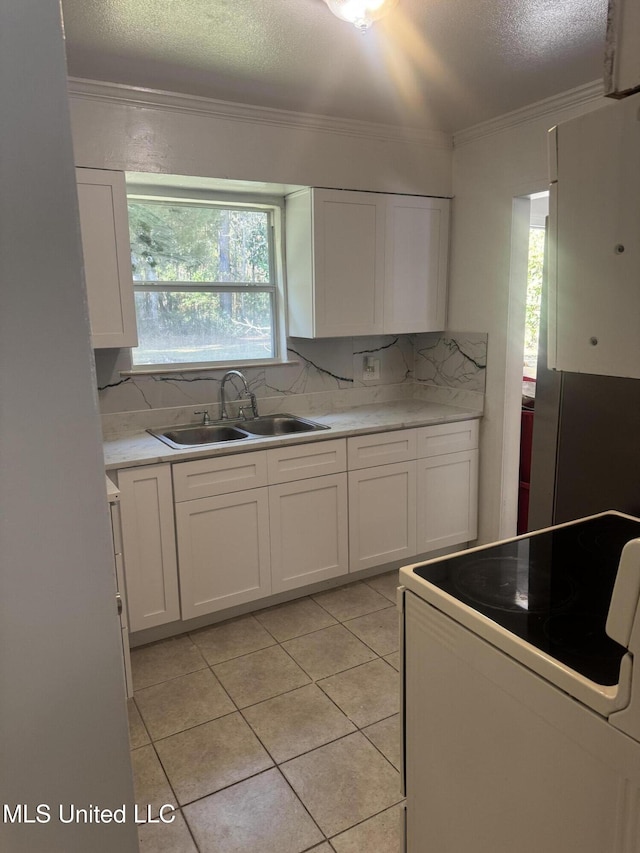 kitchen featuring white cabinets, white range with electric cooktop, sink, and ornamental molding