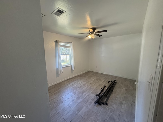 unfurnished room featuring ceiling fan and light hardwood / wood-style flooring