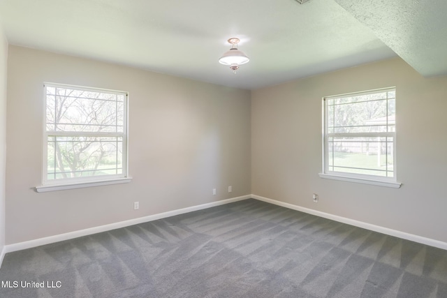 2802 Ridgewood Ave, Pascagoula, MS 39567 - empty room featuring dark carpet and baseboards