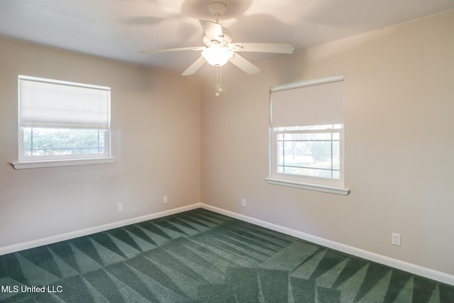 2802 Ridgewood Ave, Pascagoula, MS 39567 - empty room with dark carpet, baseboards, and ceiling fan