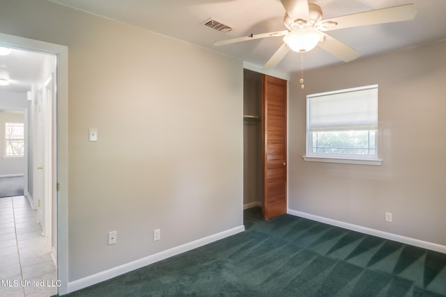 2802 Ridgewood Ave, Pascagoula, MS 39567 - unfurnished bedroom with multiple windows, a closet, baseboards, and carpet flooring