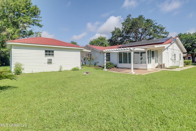 2802 Ridgewood Ave, Pascagoula, MS 39567 - back of property with a lawn, solar panels, metal roof, and a pergola