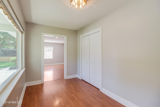 2802 Ridgewood Ave, Pascagoula, MS 39567 - unfurnished bedroom featuring wood finished floors, a closet, and baseboards