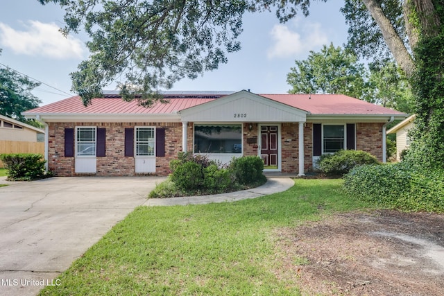 2802 Ridgewood Ave, Pascagoula, MS 39567 - ranch-style home with brick siding, concrete driveway, and metal roof