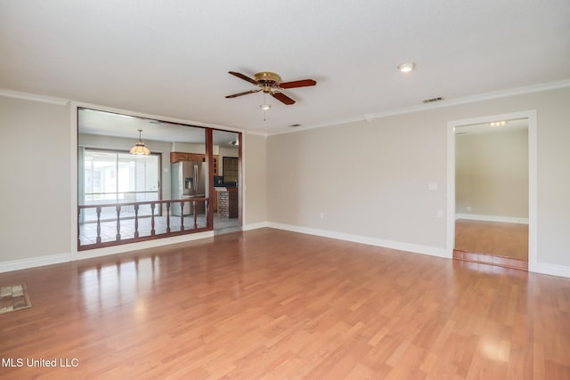 2802 Ridgewood Ave, Pascagoula, MS 39567 - unfurnished living room featuring a ceiling fan, crown molding, light wood-type flooring, and baseboards