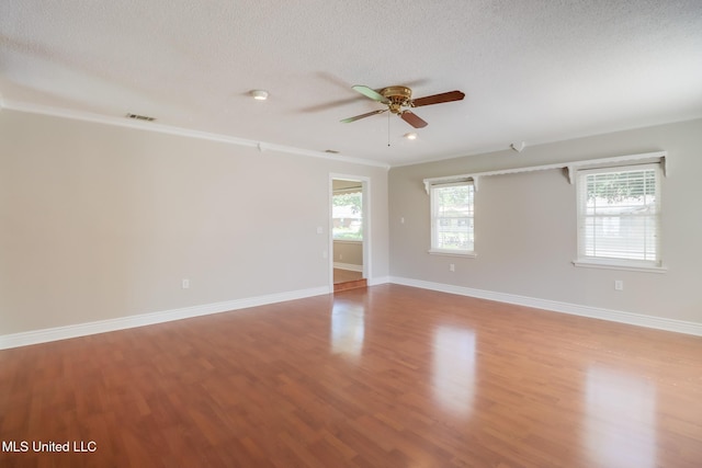 2802 Ridgewood Ave, Pascagoula, MS 39567 - spare room with a ceiling fan, plenty of natural light, wood finished floors, a textured ceiling, and baseboards