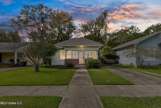 view of front facade with a carport and a yard