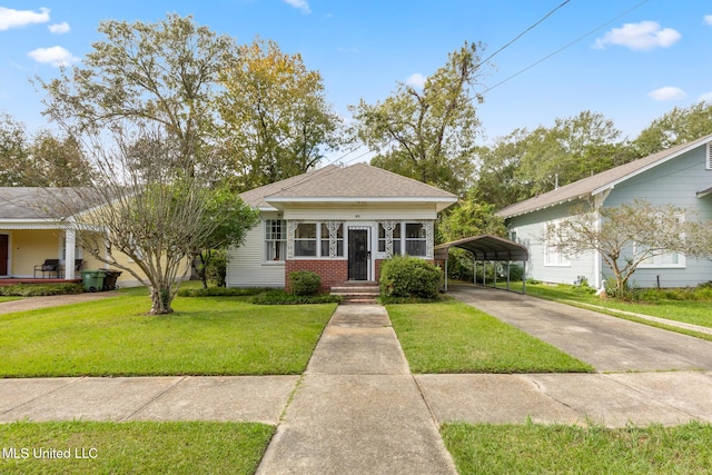 bungalow-style house featuring a carport and a front lawn