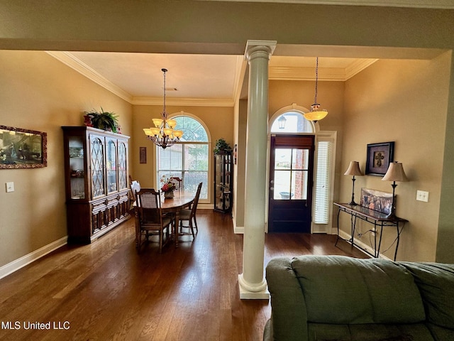 foyer with decorative columns, plenty of natural light, and crown molding