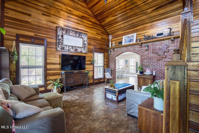 living room featuring wood walls, a healthy amount of sunlight, wood ceiling, and high vaulted ceiling