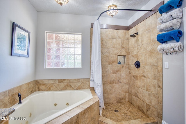 bathroom featuring a textured ceiling and shower with separate bathtub