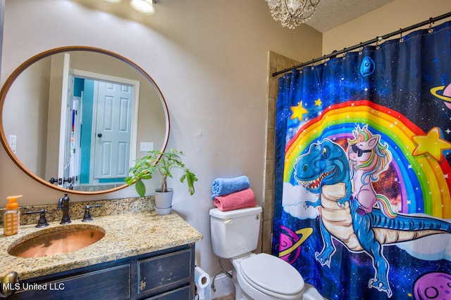 bathroom with toilet, vanity, a textured ceiling, and a shower with shower curtain