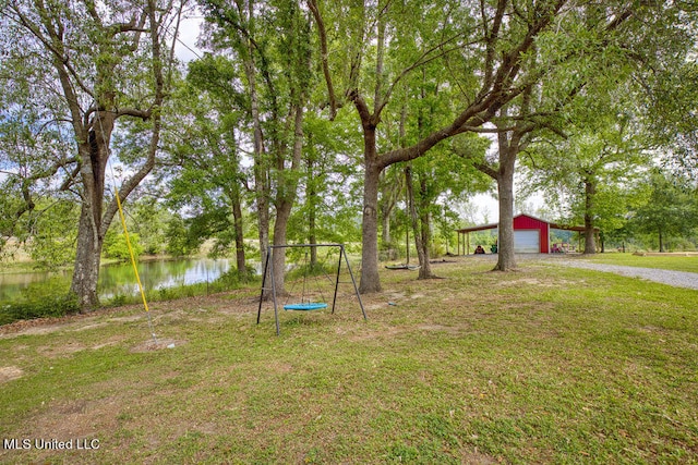 view of yard with an outbuilding and a water view