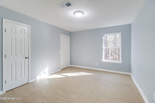 spare room featuring light wood-type flooring