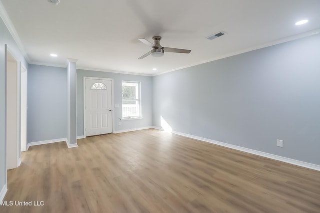 foyer entrance with ceiling fan, light hardwood / wood-style floors, and crown molding