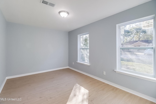 spare room with light hardwood / wood-style flooring