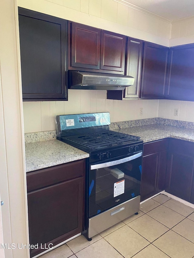 kitchen with electric stove, ornamental molding, light tile patterned flooring, and light stone counters