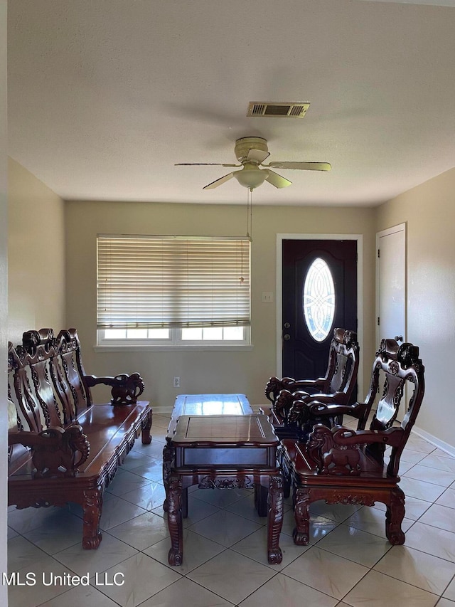 sitting room featuring tile patterned floors and ceiling fan