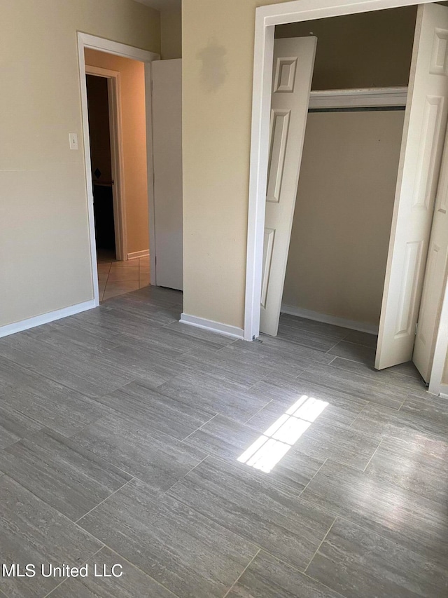 unfurnished bedroom with light hardwood / wood-style floors and a closet