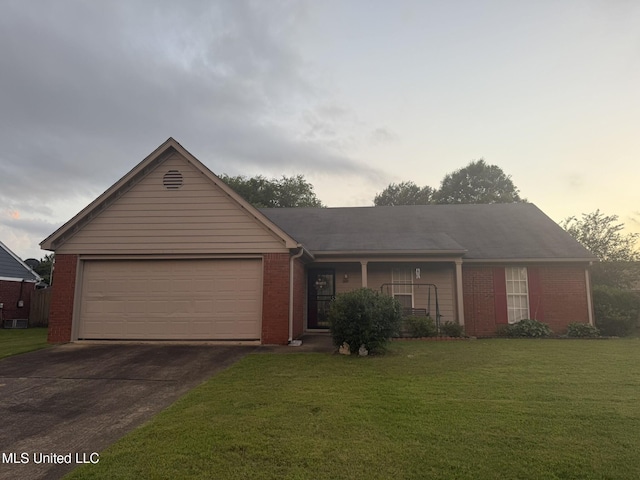 6715 Curtiss Cv, Olive Branch, MS 38654 - ranch-style house with driveway, a front lawn, brick siding, a garage, and covered porch