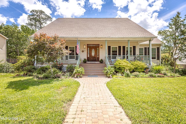 bungalow-style house featuring covered porch and a front lawn