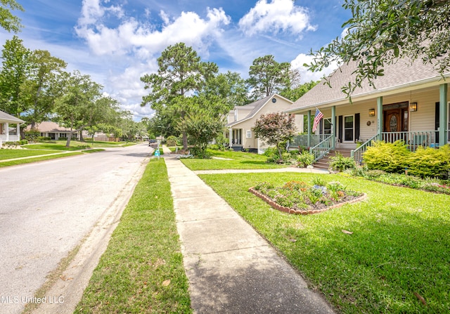 exterior space with a porch and a front lawn