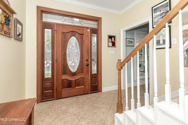 tiled foyer featuring ornamental molding