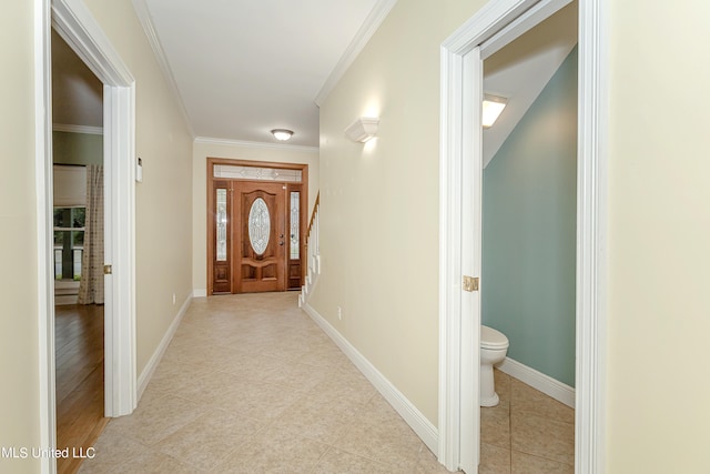 hall with ornamental molding and light hardwood / wood-style flooring