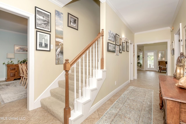 stairs with ornamental molding and tile patterned flooring