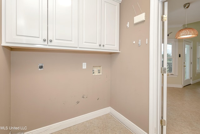 clothes washing area with hookup for a washing machine, cabinets, and hookup for an electric dryer