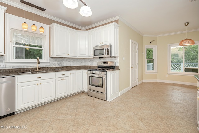 kitchen with white cabinetry, stainless steel appliances, sink, and pendant lighting