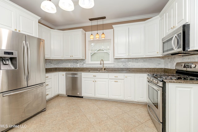 kitchen featuring sink, appliances with stainless steel finishes, hanging light fixtures, and white cabinetry