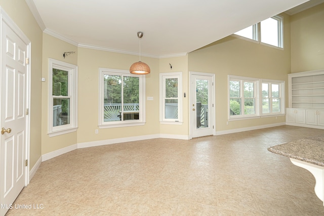 interior space featuring crown molding, light tile patterned flooring, and plenty of natural light