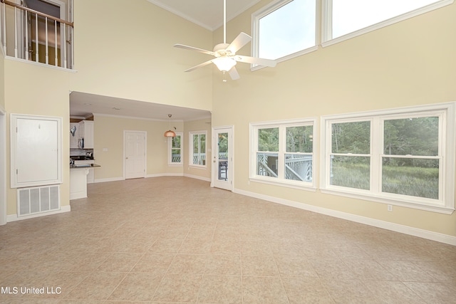 unfurnished living room with crown molding, high vaulted ceiling, and ceiling fan