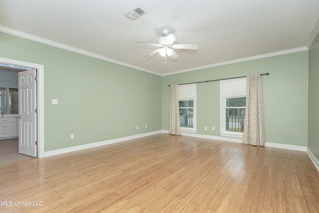 empty room featuring ceiling fan, ornamental molding, and light hardwood / wood-style flooring