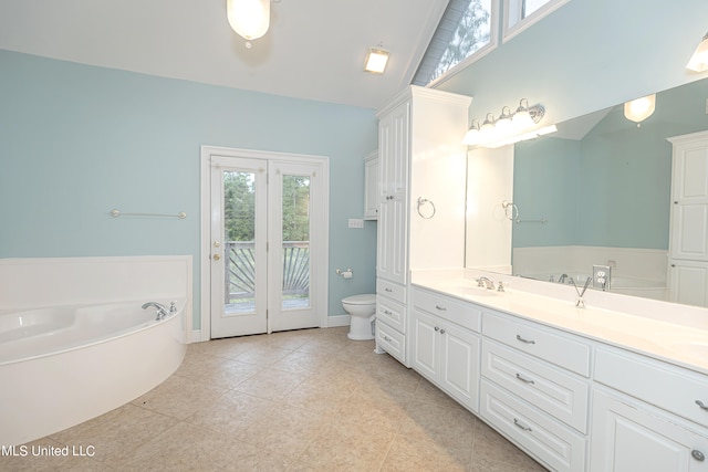 bathroom featuring toilet, tile patterned flooring, a bathtub, vaulted ceiling, and vanity