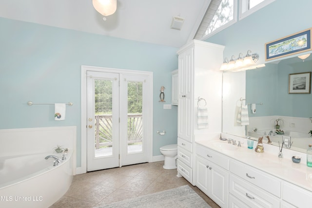 bathroom with lofted ceiling, toilet, a bath, vanity, and tile patterned flooring