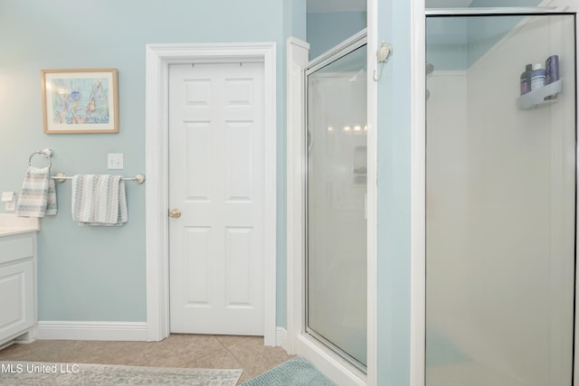 bathroom featuring vanity, tile patterned floors, and walk in shower