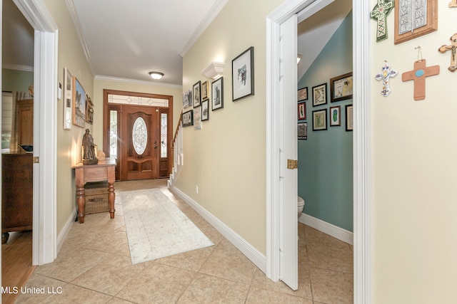 foyer entrance featuring ornamental molding and light tile patterned floors