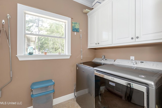 laundry area featuring cabinets, ornamental molding, and washing machine and dryer