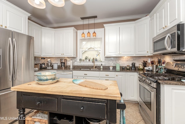 kitchen with white cabinetry, stainless steel appliances, sink, and pendant lighting