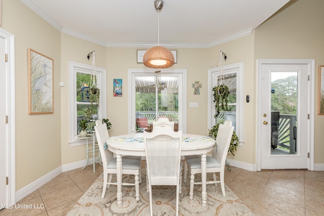 tiled dining room with ornamental molding and a healthy amount of sunlight