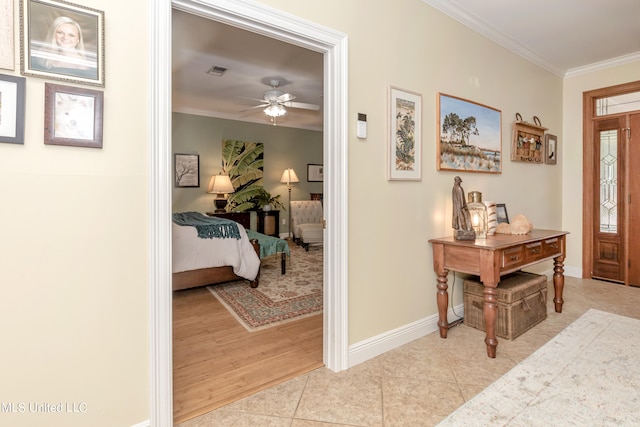 entryway with ornamental molding, light hardwood / wood-style flooring, and ceiling fan