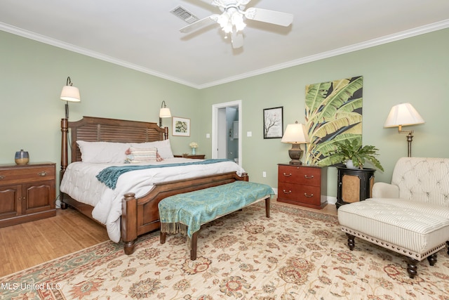 bedroom with ceiling fan, ornamental molding, and light wood-type flooring