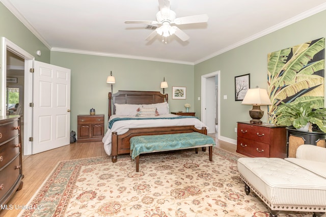 bedroom featuring ceiling fan, crown molding, and light hardwood / wood-style flooring