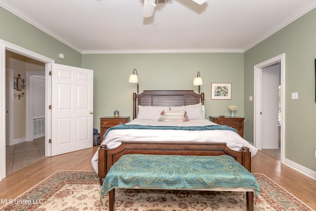 bedroom with ceiling fan, crown molding, and light wood-type flooring