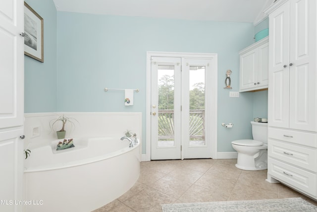 bathroom featuring toilet, a tub, and tile patterned flooring