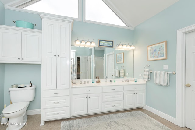 bathroom featuring a shower with door, vaulted ceiling, toilet, vanity, and tile patterned flooring